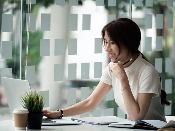 Happy asian woman using laptop computer for video conference. Online business education concept